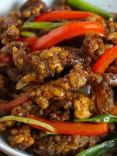 a bowl filled with meat and vegetables on top of a table