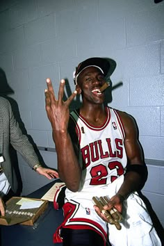 the chicago bulls'michael jordan poses for a photo in his locker room