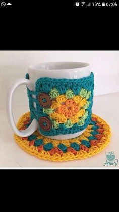 a crocheted coffee cup and saucer on a table