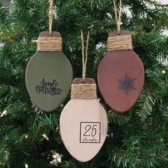 three ornaments hanging from a christmas tree with the numbers twenty five and twenty six on them