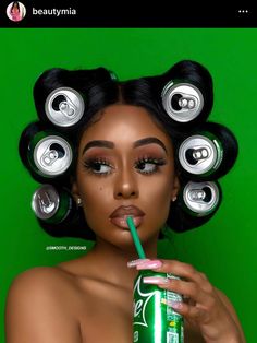 a woman is holding a drink with her hair in rollers on top of her head