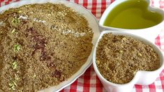 two bowls filled with green liquid next to each other on a red and white checkered table cloth