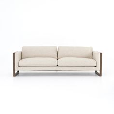 a white couch sitting on top of a wooden frame