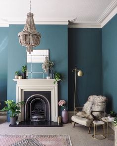 a living room with blue walls and a fireplace