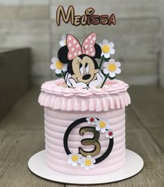 a minnie mouse birthday cake with flowers on top and the number 6 in the middle