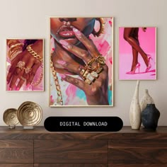 three paintings hanging on the wall above a dresser with gold jewelry and bracelets in front of them