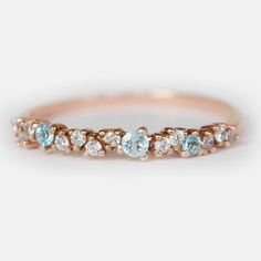 a rose gold band with blue and white diamonds