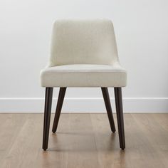 a white chair sitting on top of a hard wood floor