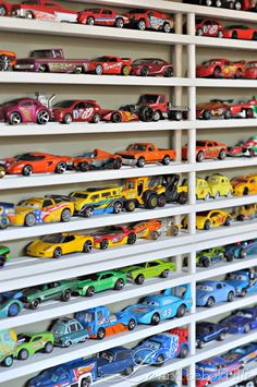 there are many toy cars on the shelves