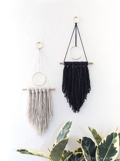 three macrame wall hangings on a white wall