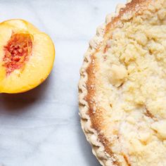 a close up of a pie on a table next to a piece of fruit and a knife