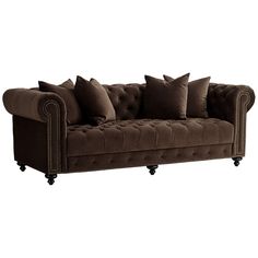 a brown couch with lots of pillows sitting on it's back legs and arms