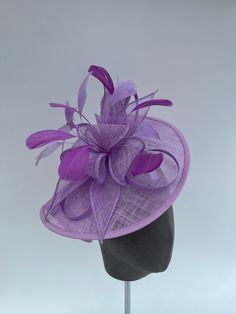 Lilac purple sinamay looped fascinator with added purple decorative feathers. This stunning fascinator has a fabulous swirl looped design and several matching purple feathers. The fascinator can be worn as a clip or headband which are both provided. These can be slid into the underside of the fascinator through an elastic attachment that keeps the headpiece securely in place.  Fascinator measures at 29x22cm Other colours and styles are available in my Etsy shop Decorative Feathers, Feathers Wedding, Purple Feathers, Model Sketch, Purple Feather, Feather Wedding, Fascinator Headband, Lilac Purple