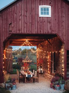 an outdoor dining area is lit up with fairy lights