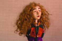 a close up of a doll with red hair