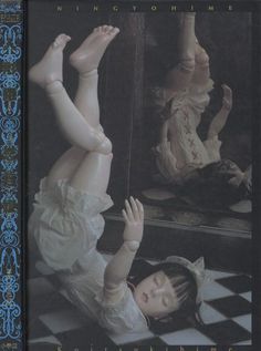 a woman laying on the ground in front of a mirror