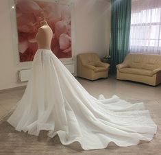 a wedding dress on display in a room