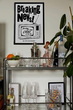 a bar cart filled with glasses and bottles