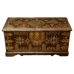 an old wooden box with decorative designs on it