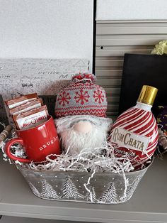 a christmas gift basket with coffee, candy and santa's sleigh ornament