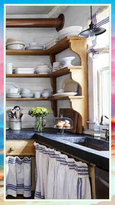 a kitchen filled with lots of white dishes and wooden shelves next to a stove top oven