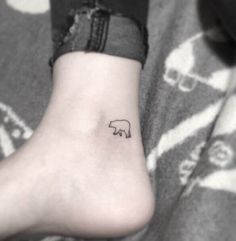 a small elephant tattoo on the ankle is shown in black and white photo, while it appears to be tiny