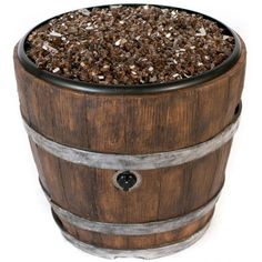 a wooden barrel filled with lots of dirt