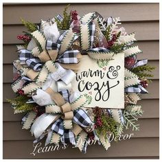 a christmas wreath with the words warm and cozy on it