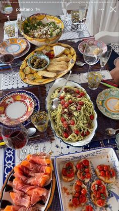 a table filled with plates and bowls of food