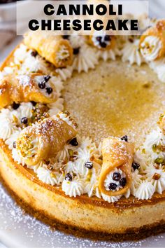 a cheesecake topped with fruit and nuts on a white platter, with the words cannoli cheesecake above it