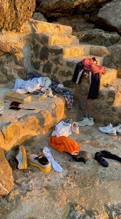 clothes and shoes are sitting on the rocks