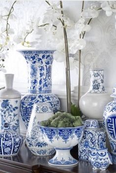 many blue and white vases on a table