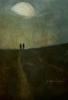 two people standing in the middle of a field under a full moon