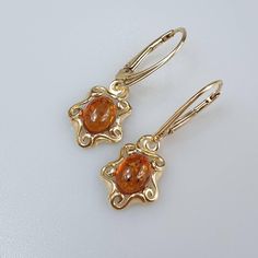 Amber Earrings, Gold Gemstone Earring, Dangle hanging crystal earrings, Christmas gift for Her.  Small and cute Baltic Amber dangle earrings for women, lever back closure. Gold plated Sterling silver 925, with stamps. Weight about 2.89 gr. length about 3 cm.  This item was made of natural Baltic Amber. All the amber used in my jewelry is collected in my home country Lithuania.  I sell only genuine,  real, not pressed, authentic, natural Baltic Amber. Item may have natural imperfections. Alt Jewelry, Hanging Crystal, Earring Dangle, Jewelry Accessories Ideas, Dope Jewelry, Amber Earrings, Earrings Christmas, Christmas Gift For Her, Jewelry Lookbook