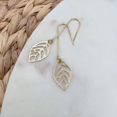 Brass, nature inspired, leaf dangly, earrings that are very unique, modern, and of course similar to the rest of this collection, lightweight. They measure just under 2 1/4 inches in total drop length and are just over 1/2 inch in width. These modern minimalist earrings are very versatile because they're easy to dress up or dress down. All earring wires or hooks are 14K gold plated. Included in your package will be a special brass polisher to help keep your jewelry always looking like new. Statement Earrings Gold, Silver Leaf Earrings, Earrings Nature, Earring Wires, Diy Wire Jewelry, Dangly Earrings, Earrings Minimalist, Earrings Statement, Leaf Shapes