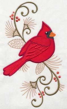 a red bird sitting on top of a white sheet with leaves and berries around it