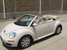 a white convertible car parked in front of a building