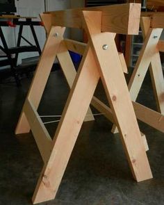 two wooden frames sitting next to each other on top of a hard wood floor in a garage