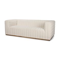 a white couch sitting on top of a wooden table