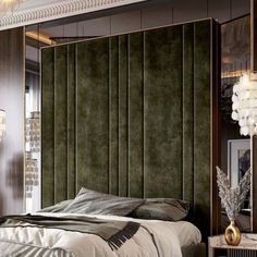 a bedroom with a green headboard and gold accents