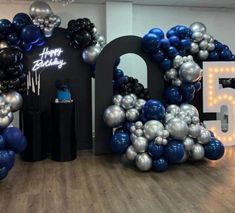 balloons are arranged in the shape of letters and numbers for a 50th birthday party at an office