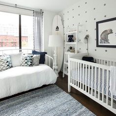 a baby's room is decorated in white and blue