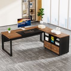 an office desk with a computer monitor and bookshelf in the corner on carpeted flooring