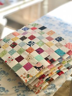 a stack of quilts sitting on top of a table