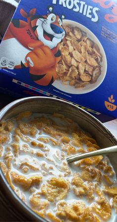 cereal in a bowl next to a box of frosting