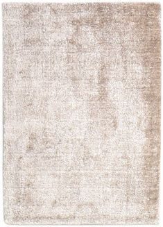 a white rug with an uneven design on the top and bottom corner, in shades of beige