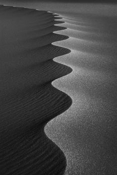 black and white photograph of sand dunes at the beach