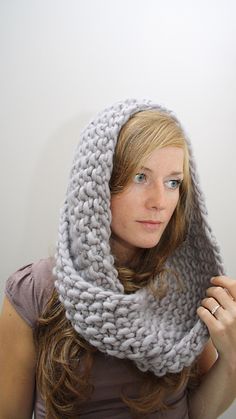 a woman wearing a gray knitted scarf