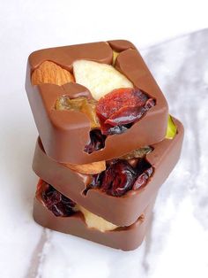 a close up of a chocolate sandwich with fruit in it on a white table top