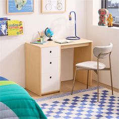 a small desk with a chair next to it in a child's playroom